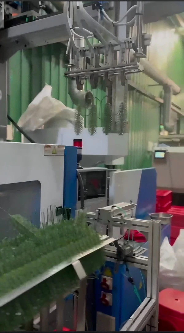 Automated robotic arm removing plastic plant parts from Haichen injection molding machine